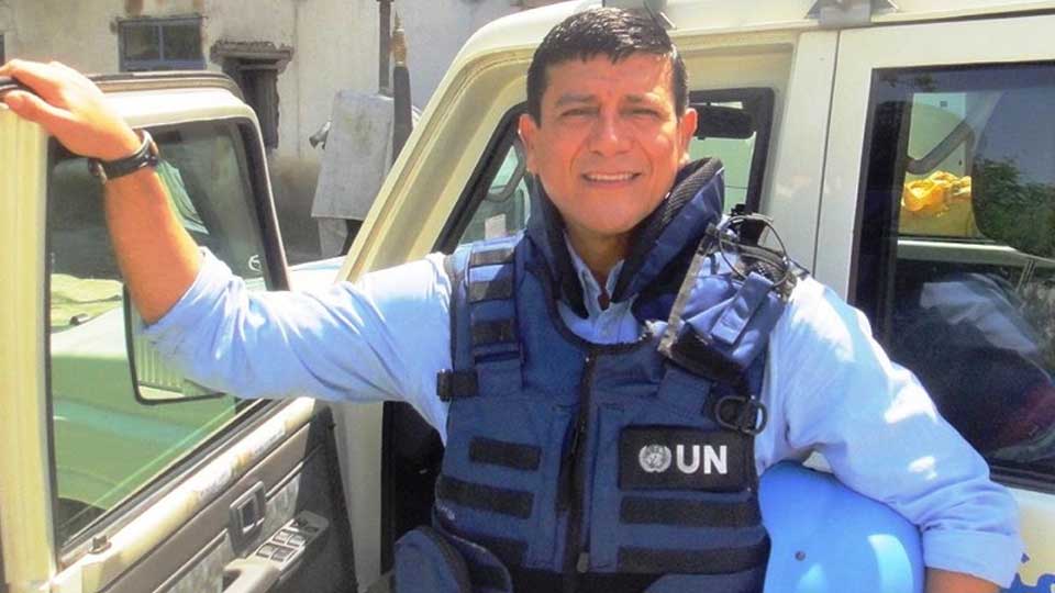 Ronnie Calitto on a UN mission. He is smiling at the camera.