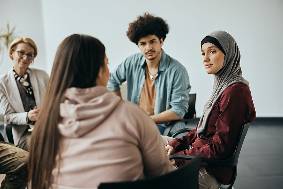 A group of young people sit at a support session.