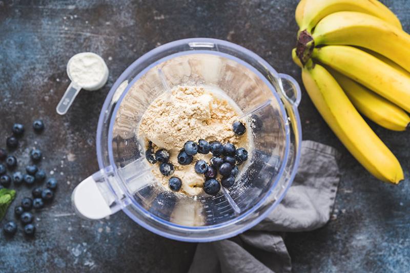 Protein powder and fruit in a blender.