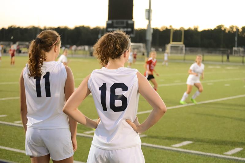 Girls on sideline of soccer match