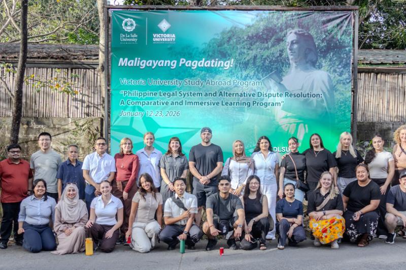 The group receive a warm welcome to De La Salle University, with a welcome banner