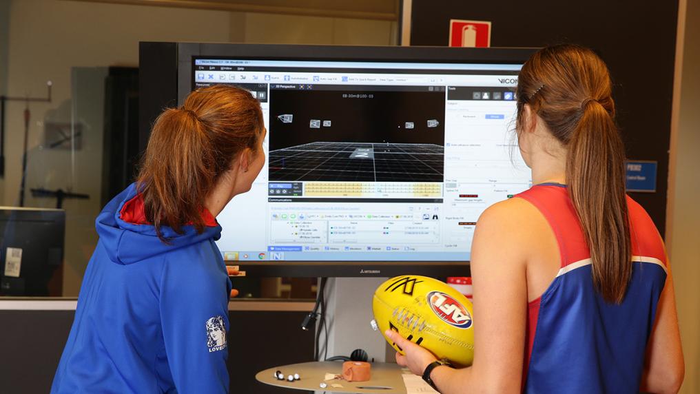 A VU sports researcher works with a Western Bulldogs player.