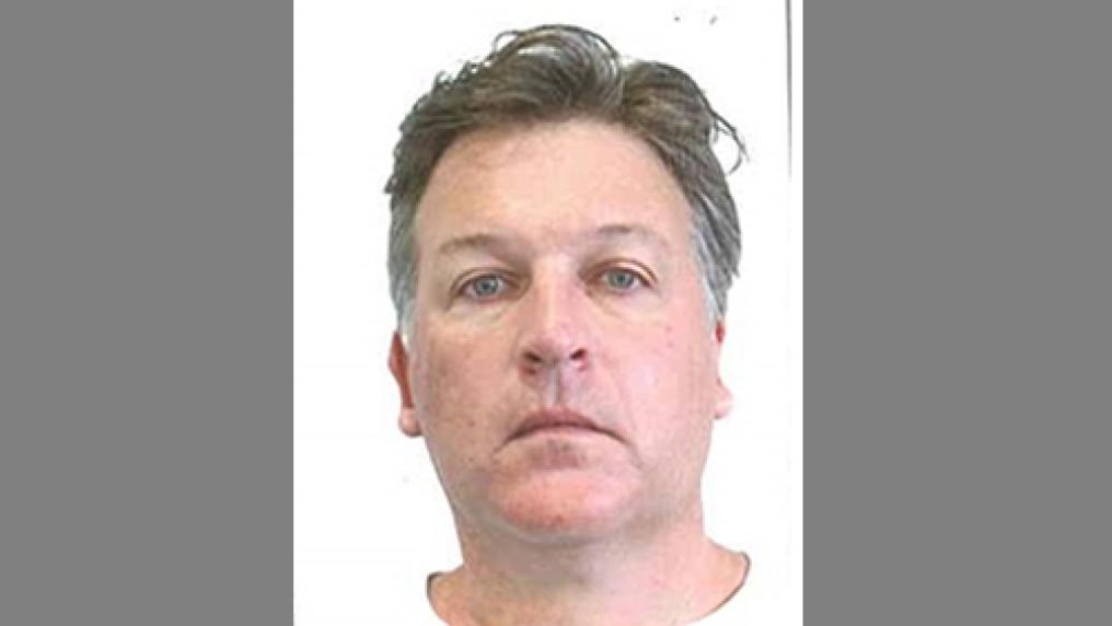 A passport style photo of a middle aged man